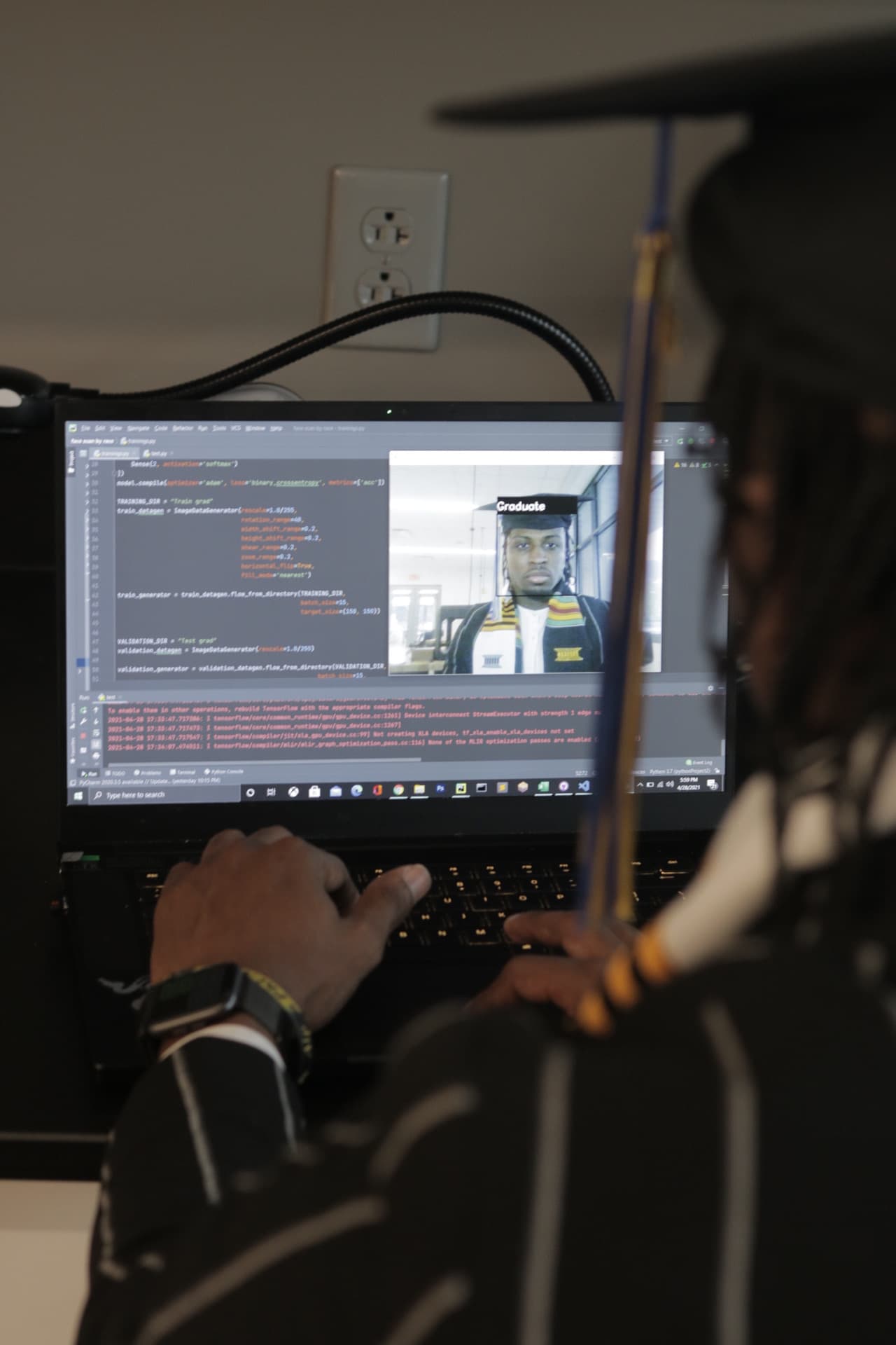 Jordan working on a computer vision project with code visible on a laptop.